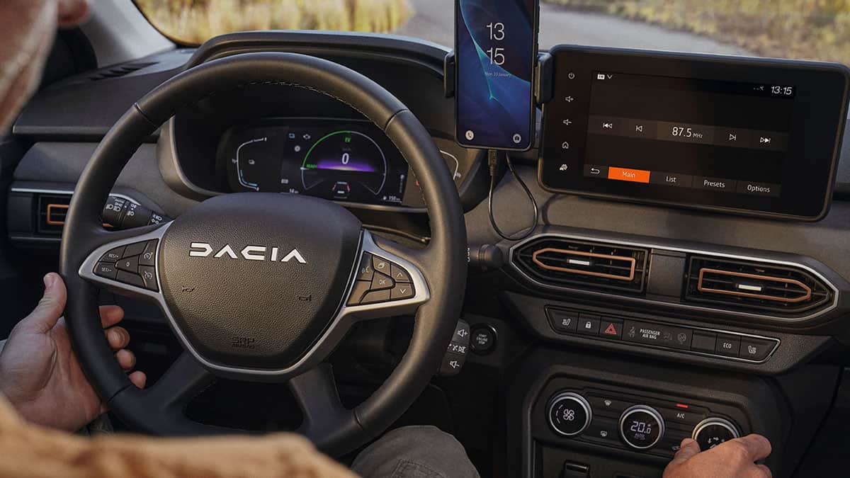 גבר נוהג בדאצ'יה ג'וגר היברידי